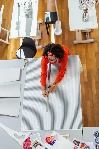A designer is pictured in their studio, surrounded by sketches, fabric swatches, and partially constructed garments. They are working on a piece that appears to be a wearable sculpture, blurring the lines between clothing and art.