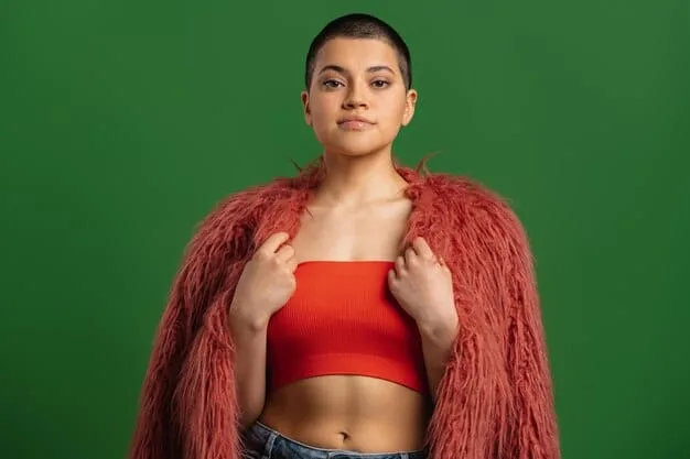A close-up shot of a model wearing a neon green crop top paired with high-waisted black pants. The model has bold, graphic eyeliner in a matching neon green, and their hair is styled in a futuristic, edgy cut. The background is a dark, gritty urban setting, emphasizing the underground fashion vibe.