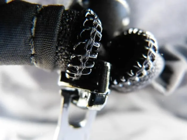 Close-up of unique details on a vintage punk rock jacket, showcasing safety pins, patches, and hand-painted designs. The jacket is worn but well-maintained, illustrating the character of vintage underground fashion.
