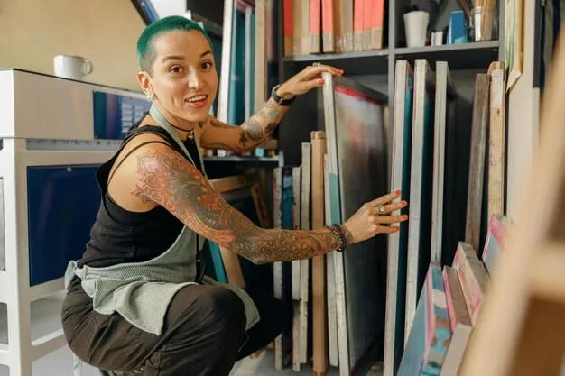 An artist inspecting a batch of newly printed art prints in a local print shop. The prints are vibrant and high-quality, reflecting the artist's meticulous attention to detail.