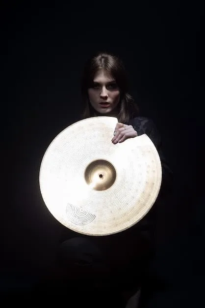 A close-up of a DJ wearing dark clothing and occult symbols, playing vinyl records in a dimly lit space. The DJ's face is partially obscured by shadows, enhancing the mysterious atmosphere.