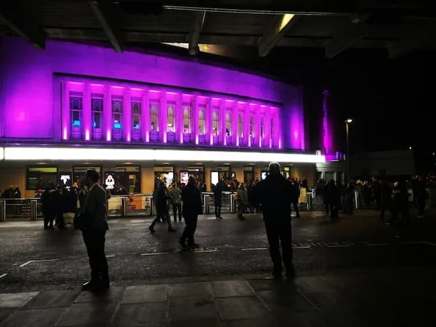 An exterior shot of a vibrant movie palace, showcasing diverse crowds from all backgrounds in stylish contemporary attire, the marquee glows with the names of both local and internationally recognized films and filmmakers.
