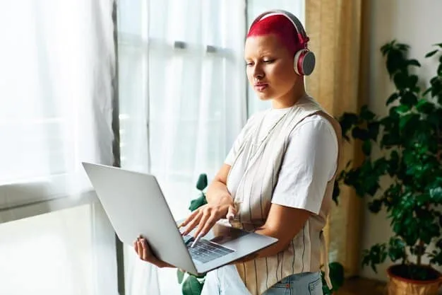 A person using a laptop to research music playlists and curators, with headphones on and a focused expression, illustrating the importance of diligent research.