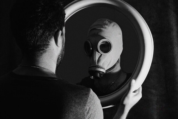 A black-and-white close-up photo capturing the intense expression of an avant-garde filmmaker during a Q&A session at an underground film festival. The background is intentionally blurred to emphasize the filmmaker's passion and artistic persona.