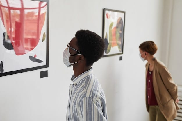 A diverse group of artists installing artwork in a non-traditional exhibition space, such as a warehouse or community center. The image showcases the DIY aesthetic, with exposed brick and industrial elements. The artists are collaboratively hanging paintings, sculptures, and mixed-media pieces, emphasizing the collective's hands-on approach.