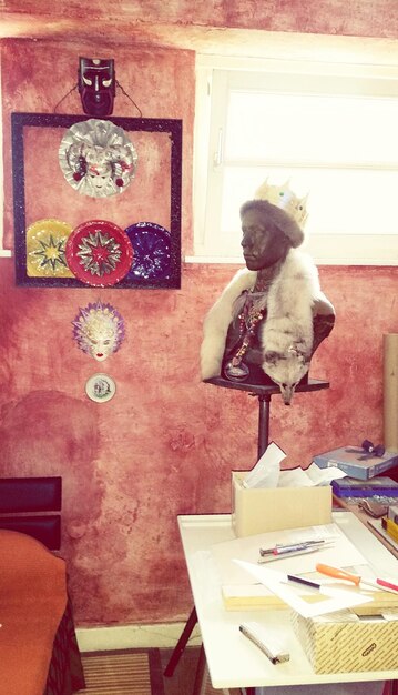 Inside a shared studio space, artists work on diverse projects: painting, sculpture, and digital art. Tools and materials are visible, creating a sense of organized chaos and creative energy.