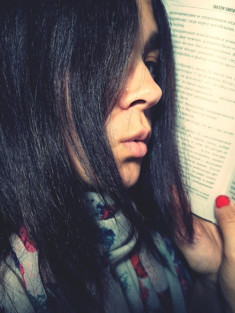 A close-up shot of Maya Rodriguez, a young Latina author, speaking passionately at a book signing event. She is holding her novel, 