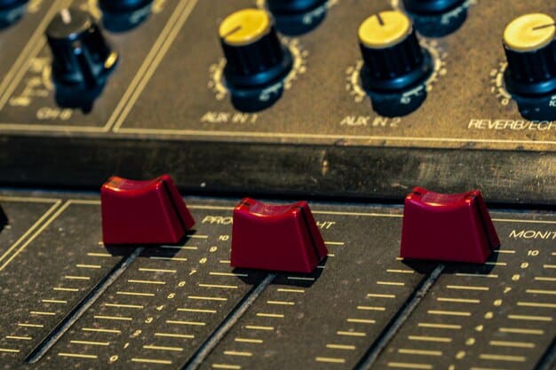 A close-up shot of a mixing board in a DIY music venue. The board is labeled with colorful tape, and various knobs and sliders are being adjusted by a sound engineer. The focus is on the technical equipment and the hands operating it.