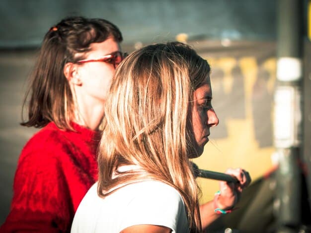 A close-up shot of two people smiling and talking animatedly at an underground film festival. The background is blurred, focusing on the interaction and sense of community.