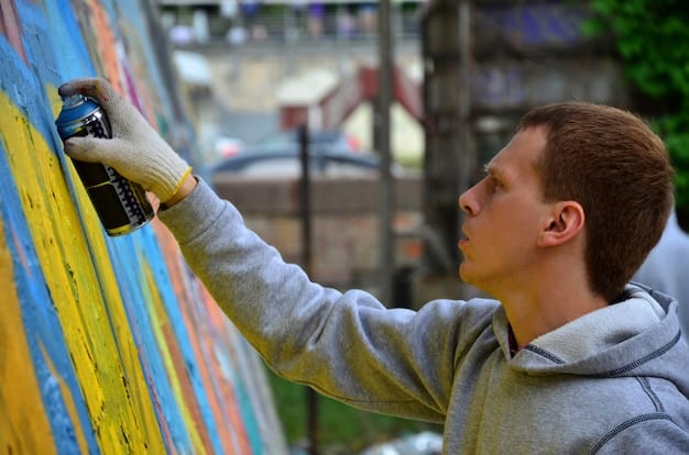 A close-up shot of a street artist creating a mural. He is using spray paint and stencils to create a vibrant and intricate design. The image highlights the skill and creativity involved in street art.