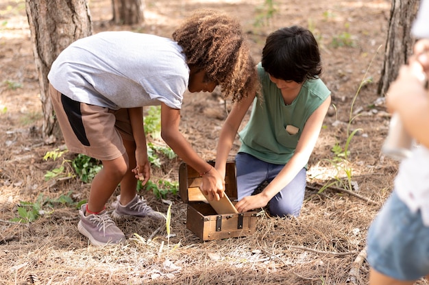 A group of Waterside School students participating in a community service project, planting trees in a local park. Teachers and community volunteers are working alongside them.