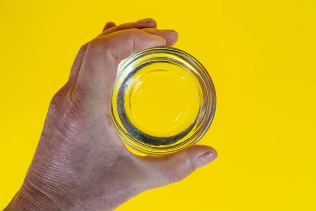 A close-up shot of a hand carefully holding a petri dish containing a colorful, glowing bacteria colony. The background is blurred, focusing the viewer's attention on the intricate details of the biological experiment.