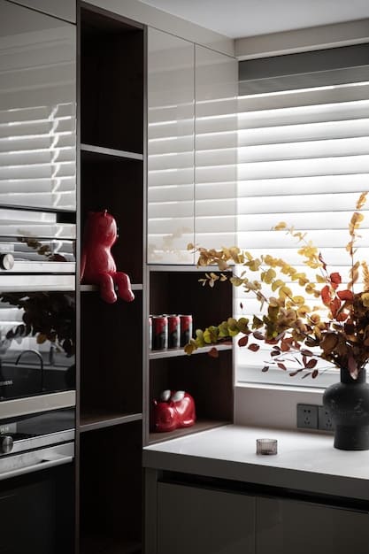 Interior of a meticulously organized and aesthetically pleasing van, showcasing minimalist decor, a small kitchen area, and storage solutions. Natural light streams in through the windows.