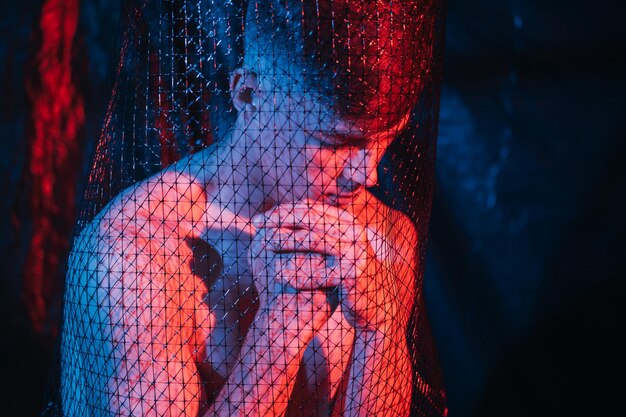 A close-up shot of a singer performing passionately during a virtual concert, bathed in vibrant stage lighting, with visible online fan reactions and comments scrolling on a nearby screen, showcasing the energy and immediacy of the digital performance.