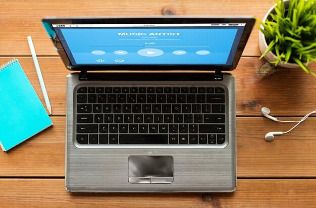 A close-up shot of a Spotify for Artists dashboard on a laptop screen, highlighting key analytics metrics such as streams, listeners, followers, and playlist adds. The screen is well-lit and the metrics are clearly visible.