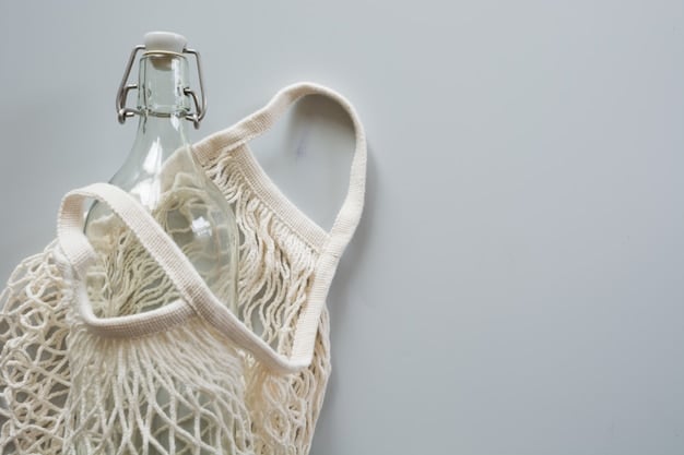 Close-up shot of various sustainable and recycled textiles, including fabrics made from recycled plastic bottles, organic cotton, and hemp. The focus is on the textures and colors of the fabrics, showcasing their potential for use in high-fashion designs.