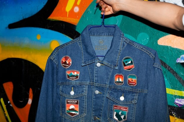 A person customizing a denim jacket with various patches and pins, showcasing different designs and textures. The person's hands are visible, carefully attaching a patch with needle and thread in a well-lit, creative studio setting.
