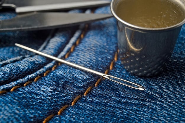 Close-up photo of hands sewing or altering a garment made from upcycled denim. The focus is on the texture and detail of the repurposed material and the hands working on it, hinting at slow, sustainable craftsmanship.