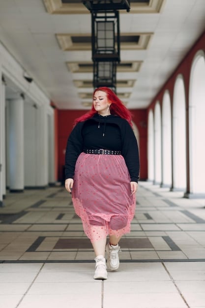 A plus-size model confidently walking a runway during an underground fashion show. They are wearing a bold and colorful outfit that accentuates their curves and showcases their personal style. The audience is diverse and supportive, cheering them on. The atmosphere is energetic and empowering.