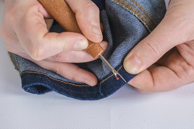 Close-up shot of hands sewing together pieces of fabric from old jeans to create a new garment, with natural light filtering through a window, highlighting the texture and details of the denim and stitching. Tools include sewing machines and spools of threads, showing a focus on DIY and upcycling.