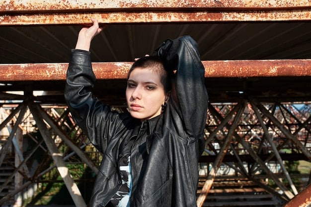 A close-up shot of a punk rock fan's outfit, showcasing a heavily customized leather jacket with band patches, safety pins, and hand-painted designs. The jacket should appear worn and distressed, reflecting the DIY ethos of the punk subculture.