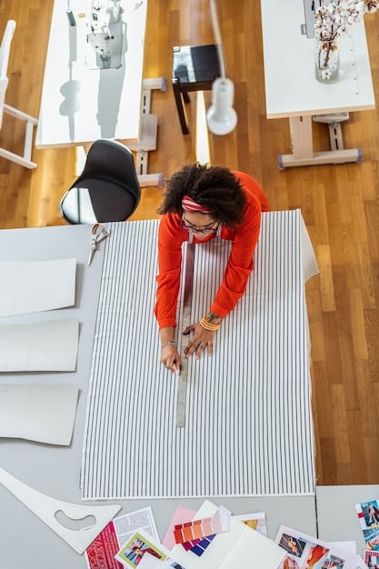 A designer is pictured in their studio, surrounded by sketches, fabric swatches, and partially constructed garments. They are working on a piece that appears to be a wearable sculpture, blurring the lines between clothing and art.