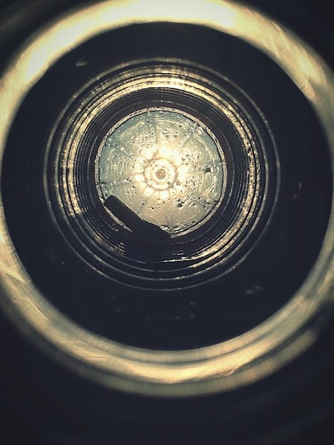 A close-up, stylized shot of a vintage film camera lens with light refractions, symbolizing the focus and artistic vision of alternative filmmaking.
