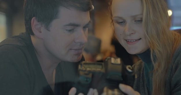 A close-up of a film director interacting with actors on a film set, showing a collaborative and community-oriented approach to filmmaking, reflecting the spirit of platforms like Seed&Spark.