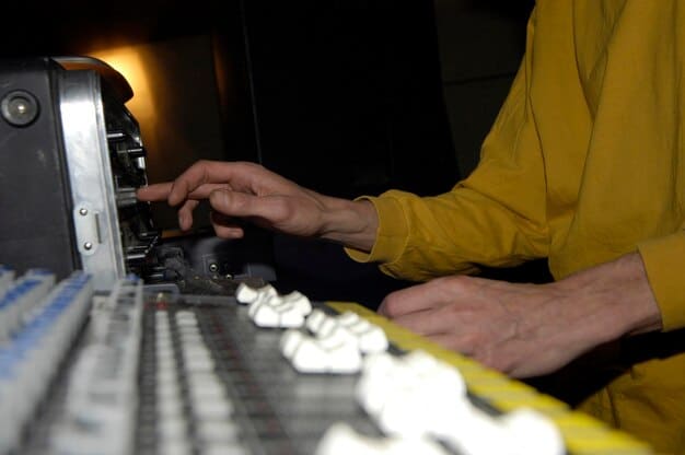 A close-up of a musician's hands meticulously adjusting knobs on a complex modular synthesizer, bathed in the glow of a laptop screen displaying intricate audio waveforms, symbolizing experimental electronic music creation.