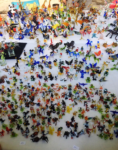 A vibrant pop-up art installation featuring a mural being painted live, surrounded by an enthusiastic crowd watching a spoken word poet perform in an urban public square.